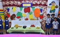 Nursery children with a fruit display as part of their learning