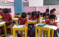 Students drawing at classroom desks