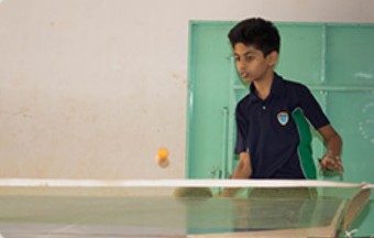 A student playing table tennis